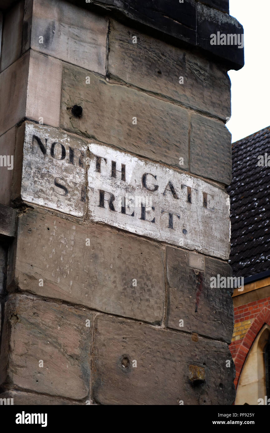 Northgate street sign handpainted on high up section of old stone wall ...