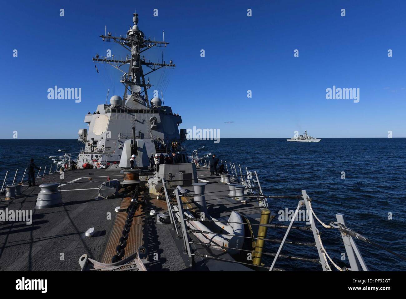 SEA (June 6, 2018) The Arleigh Burke-class guided-missile destroyer USS Bainbridge (DDG 96) and the Royal Navy’s Duke-class frigate HMS Monmouth (F 235) approach the German Berlin-class replenishment ship Frankfurt am Main (A 1412) for refueling during exercise Baltic Operations (BALTOPS) 2018. BALTOPS is the premier annual maritime-focused exercise in the Baltic Region and one of the largest exercises in Northern Europe that is designed to enhancing flexibility and interoperability among allied and partner nations. Stock Photo