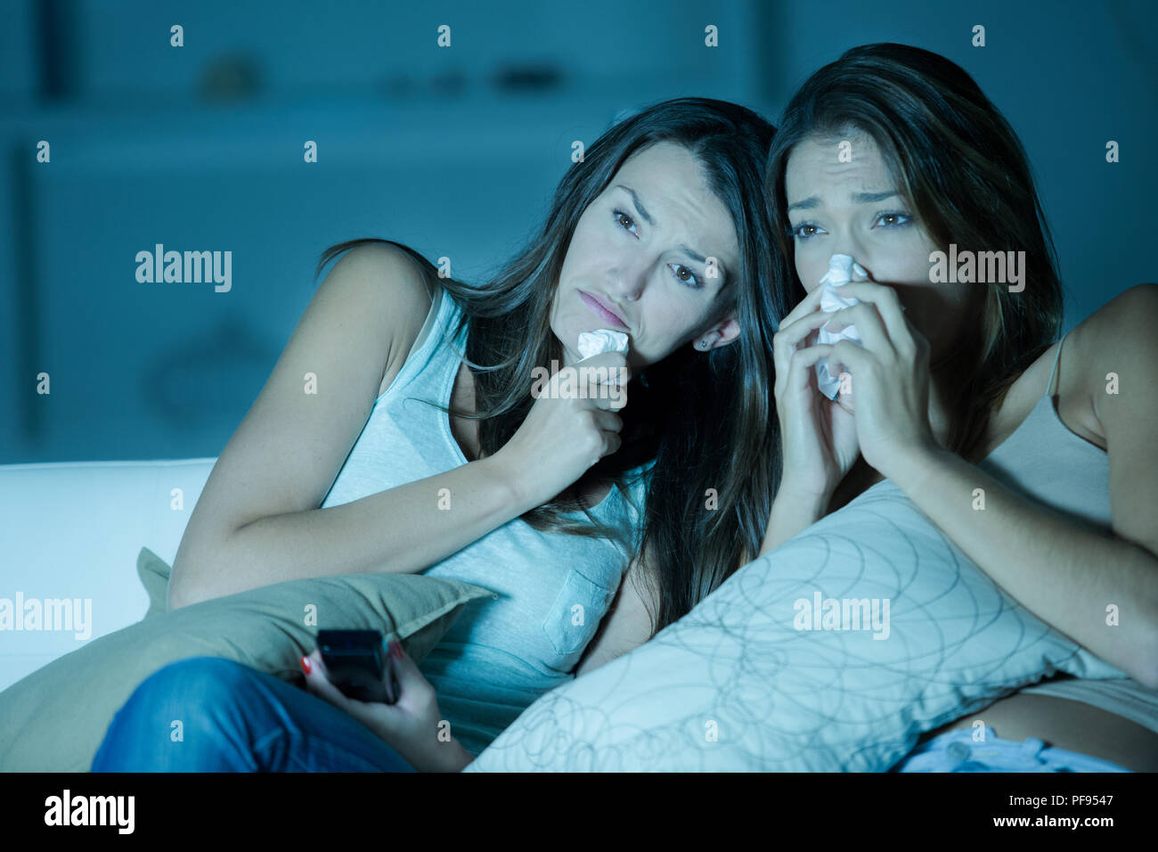 Women sobbing while watching movie Stock Photo