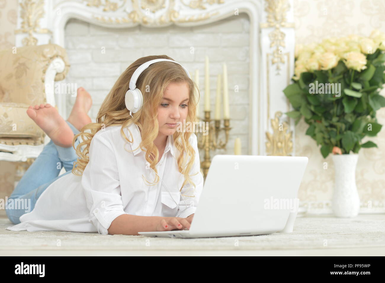teenage girl in headphones lying on floor Stock Photo - Alamy