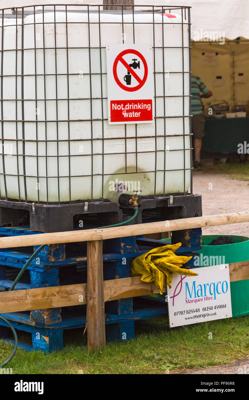 Large container of water not suitable for drinking with not drinking water sign at Horton, Dorset UK in August Stock Photo