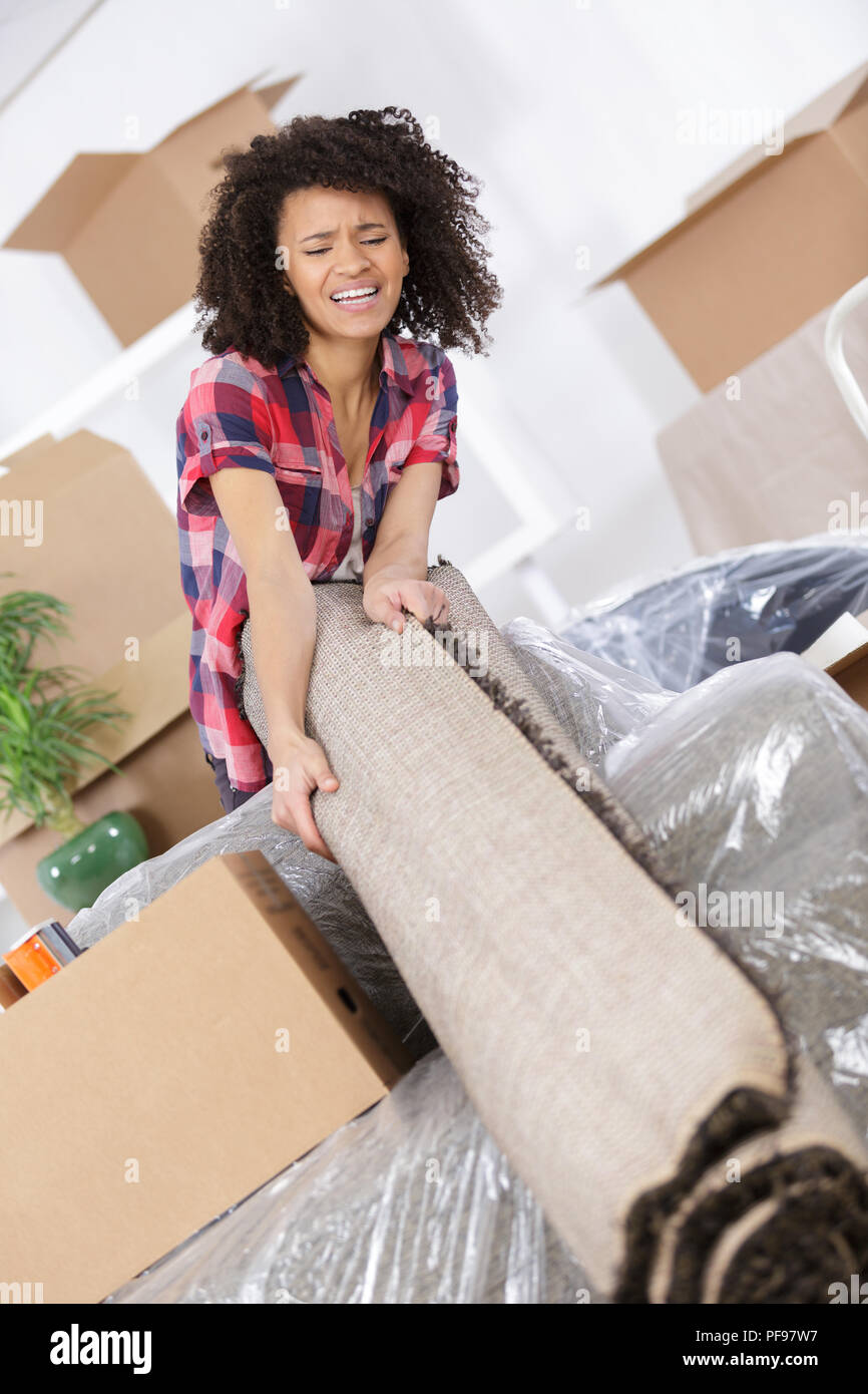 woman carrying heavy carpet Stock Photo Alamy
