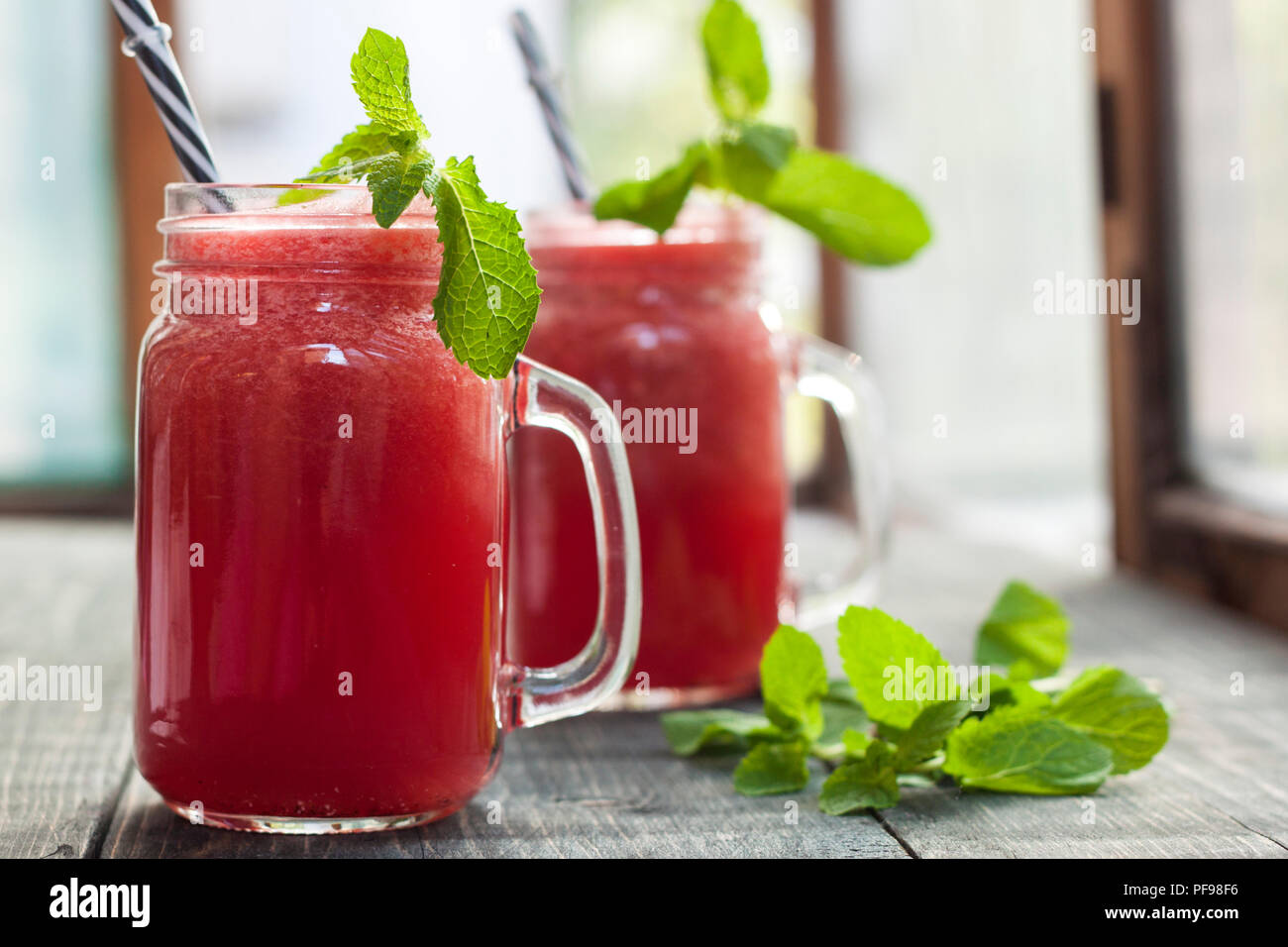 Tasty fresh appetizing watermelon drink smoothie. Watermelon drink in glass mugs Stock Photo