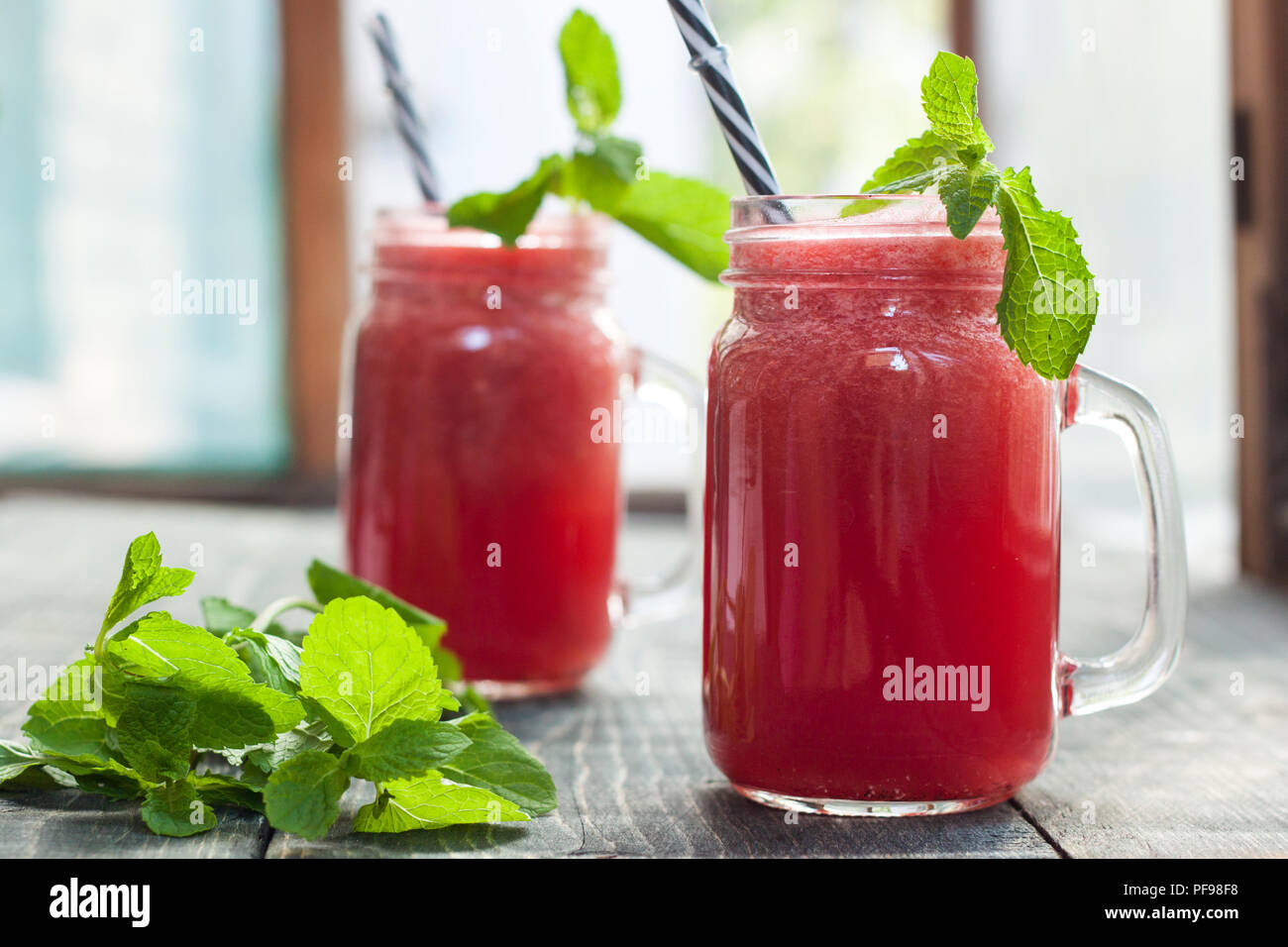Tasty fresh appetizing watermelon drink smoothie. Watermelon drink in glass mugs Stock Photo
