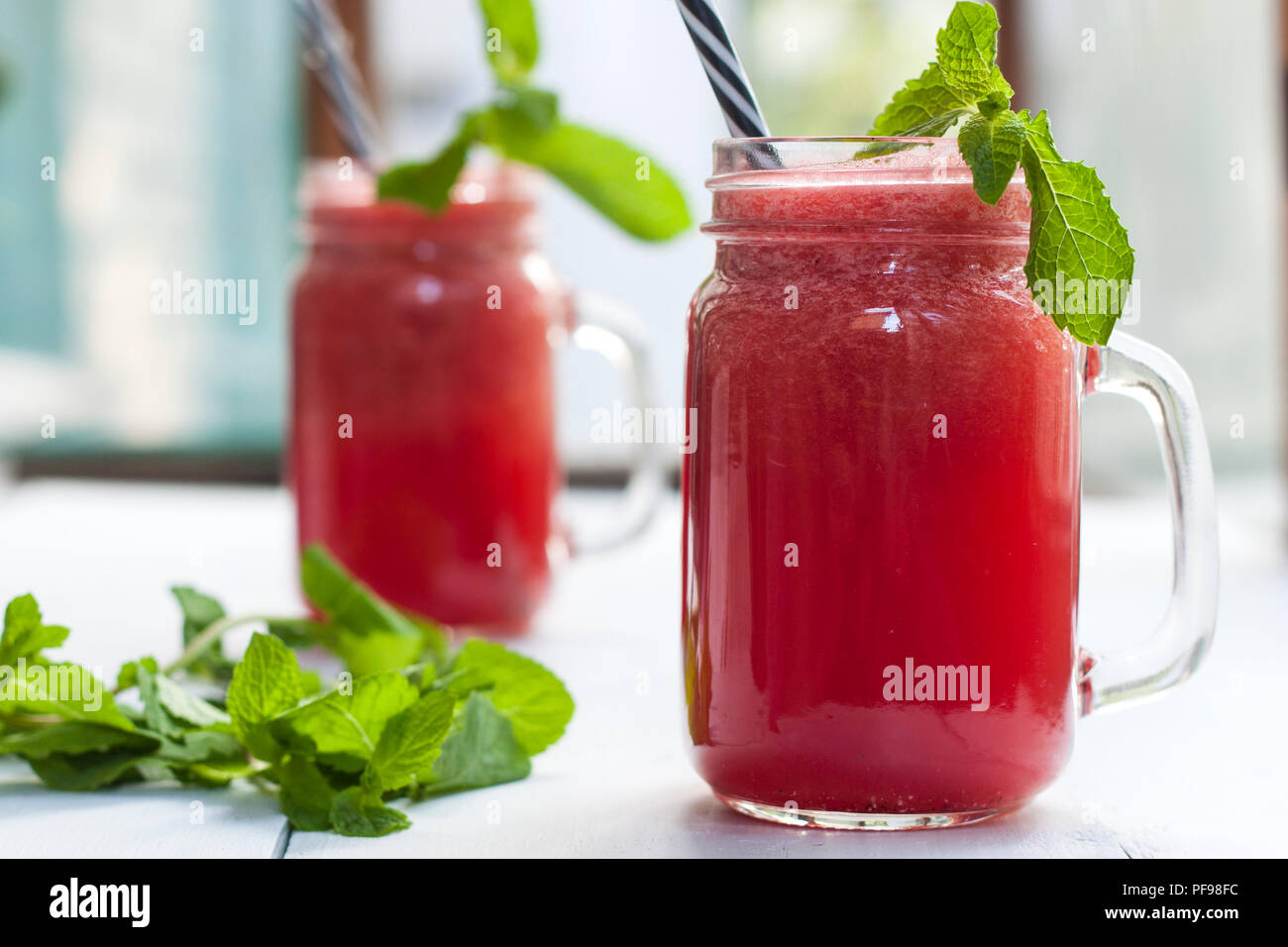 Tasty fresh appetizing watermelon drink smoothie. Watermelon drink in glass mugs Stock Photo