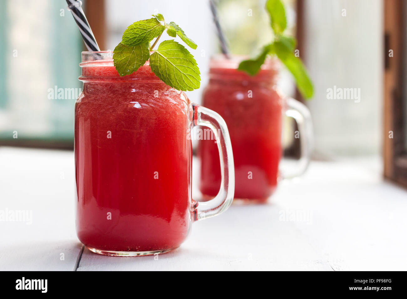 Tasty fresh appetizing watermelon drink smoothie. Watermelon drink in glass mugs Stock Photo