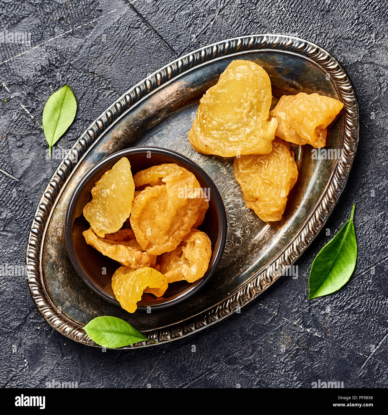 Dried pear, apricot or peach on black background. Top view of candied fruits. Stock Photo