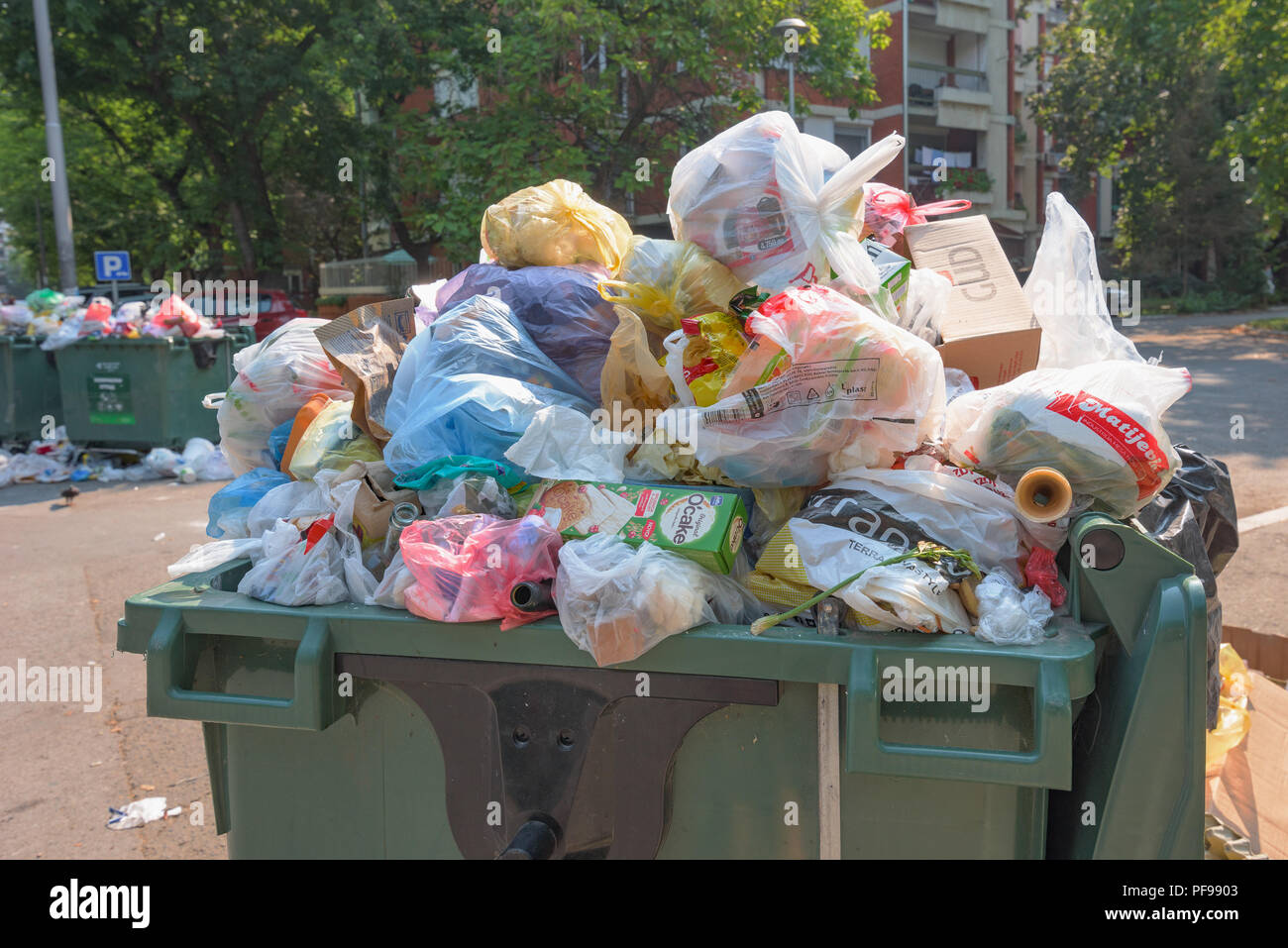 NOVI SAD, SERBIA - AUGUST 18, 2018: Municipal solid waste or communal garbage is overflowing containers in Novi Sad during weekends, illustrative edit Stock Photo