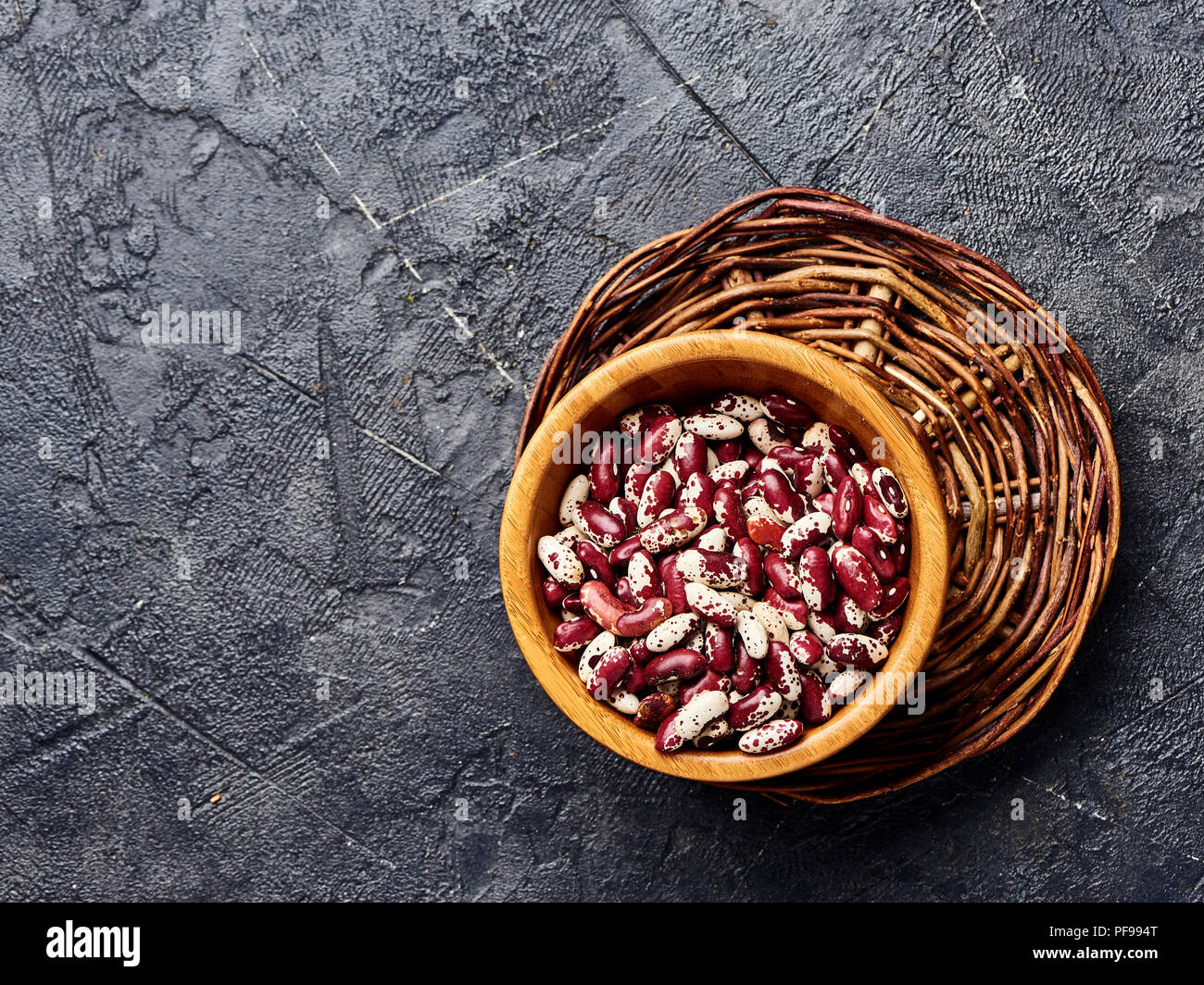Red beans with white spots on black background. Top view. Stock Photo
