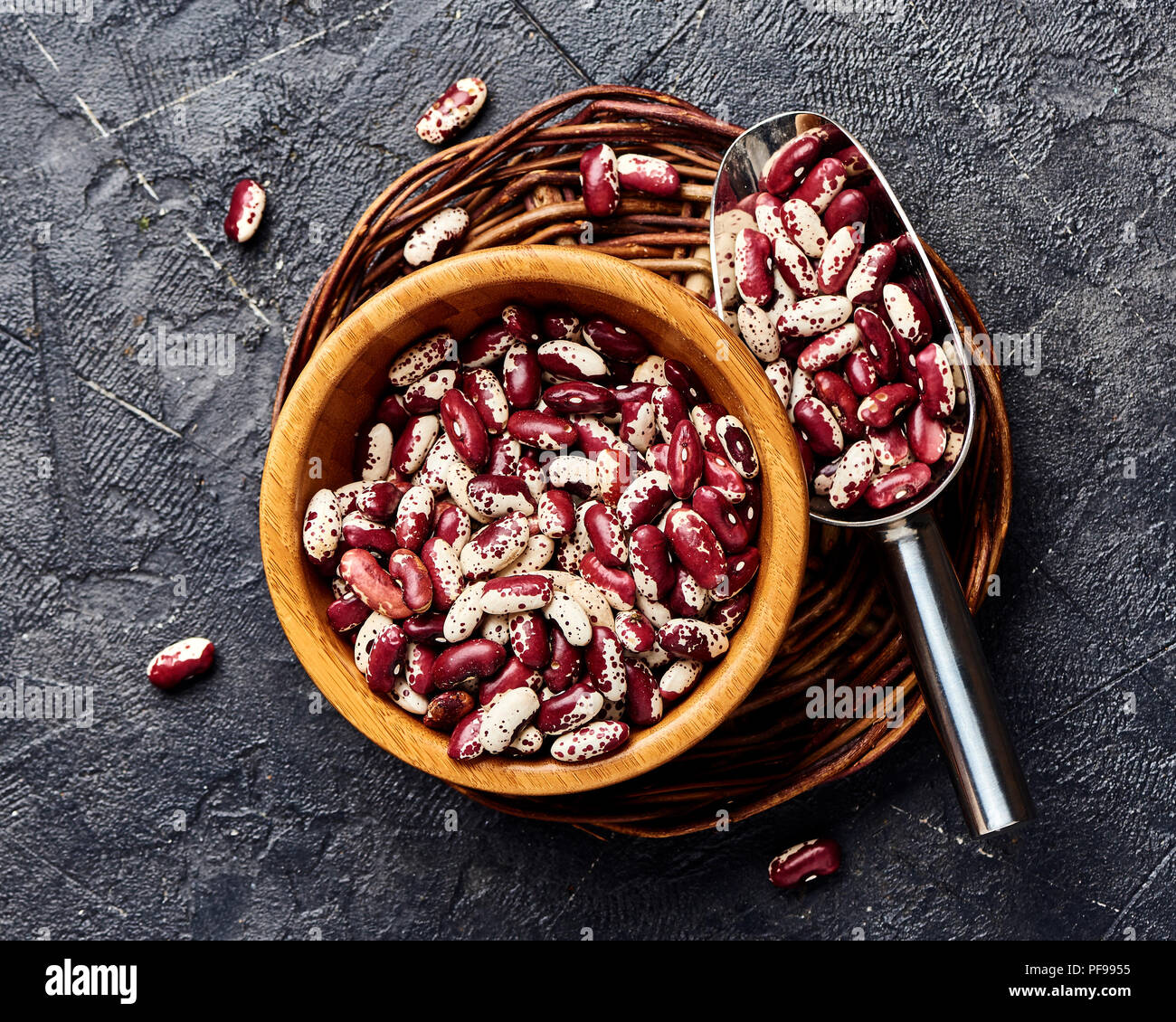 Red beans with white spots on black background. Top view Stock Photo