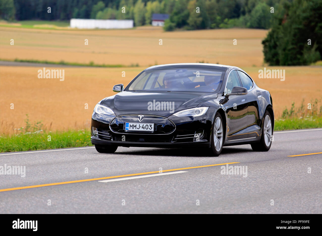 Salo, Finland - August 5, 2018: Black Tesla Model S electric car moves along rural highway on a day of early autumn. Stock Photo