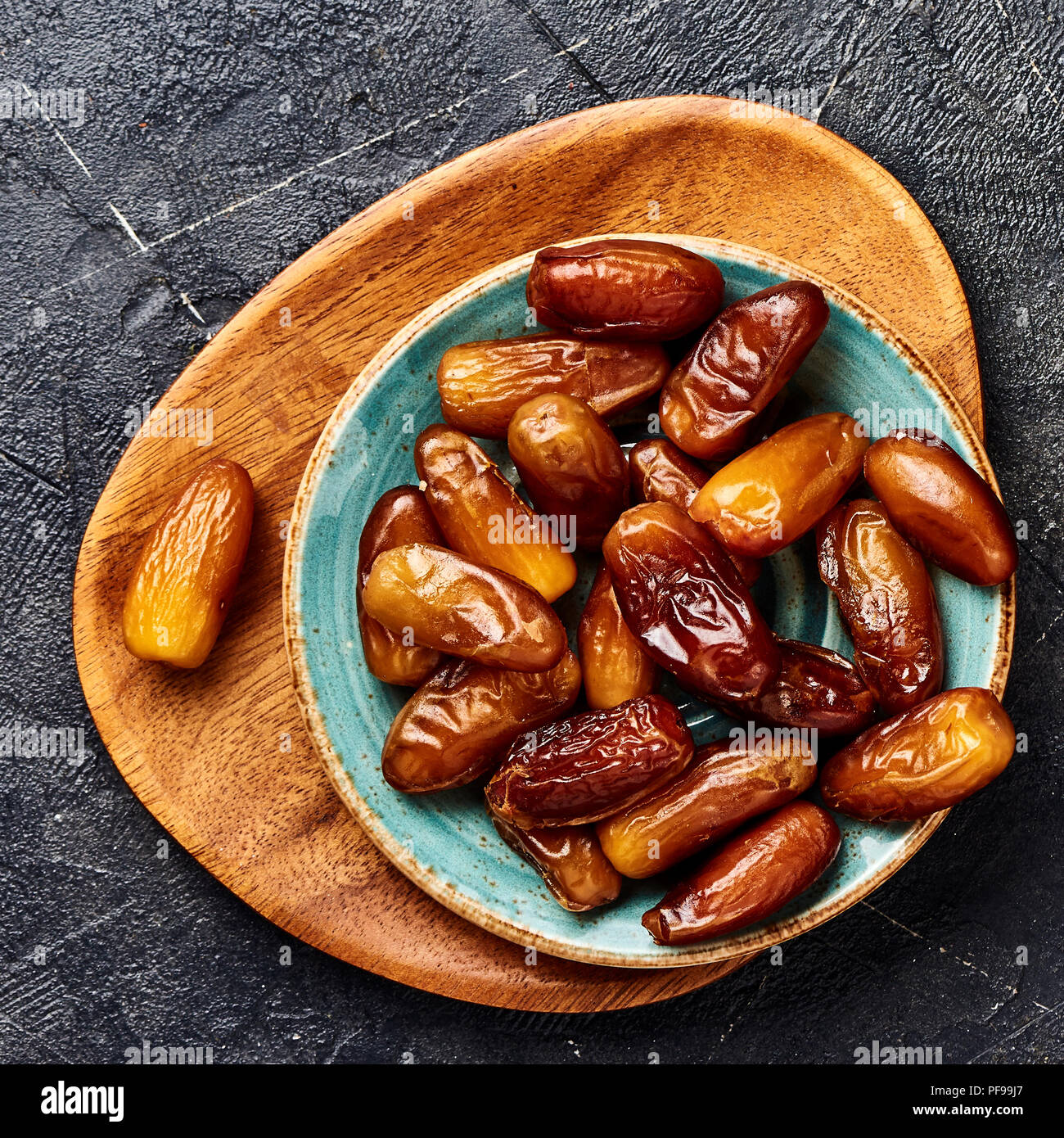 Dried dates fruits on plate. Top view of pitted dates. Stock Photo