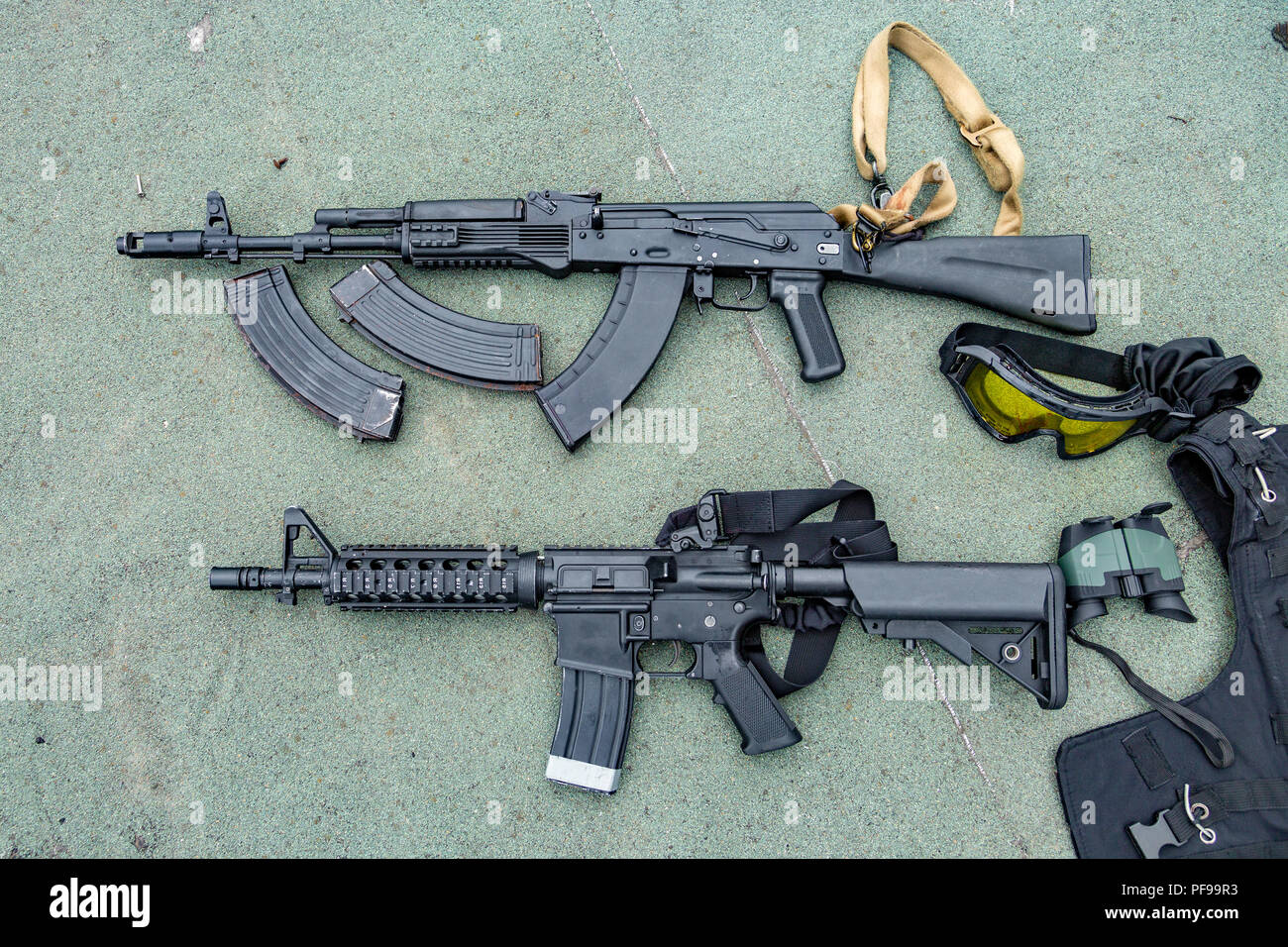 Weapons on the ground. Rifles pistols guns body armor Stock Photo Alamy