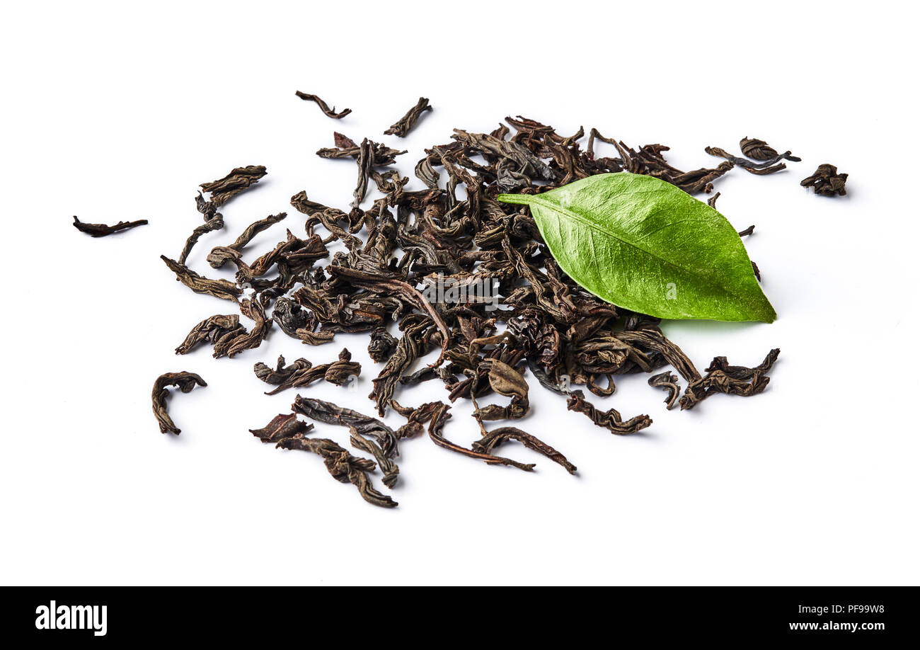 Heap of dried black tea leaves isolated on white background. Stock Photo