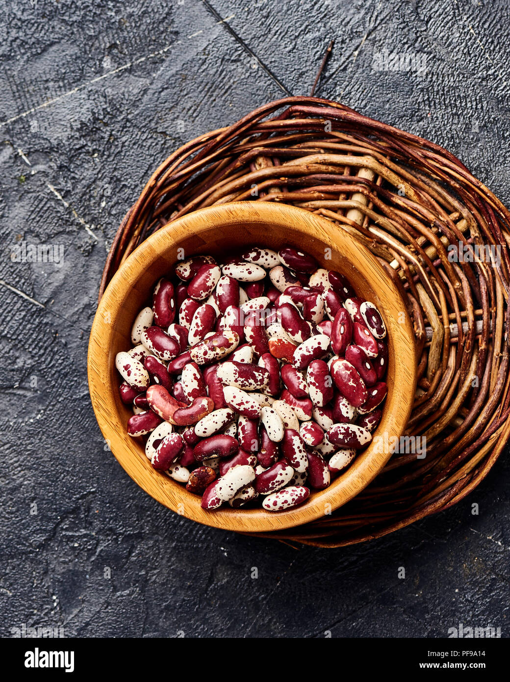 Red beans with white spots on black background. Top view Stock Photo