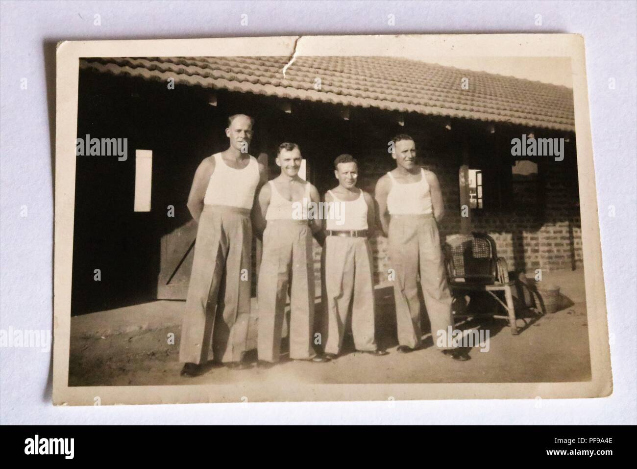 Social History - Black and white old photograph showing 4 men posing for photo, possibly at work, all wearing vests and trousers 1930s Stock Photo