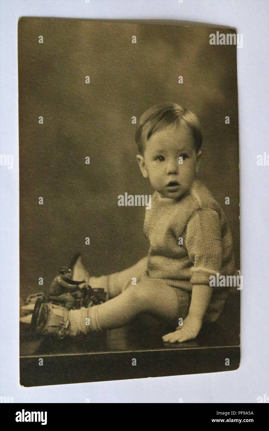 Social History - Black and white old photograph showing a portrait of a young boy wearing tank top, shorts and sandals - 1930s Stock Photo