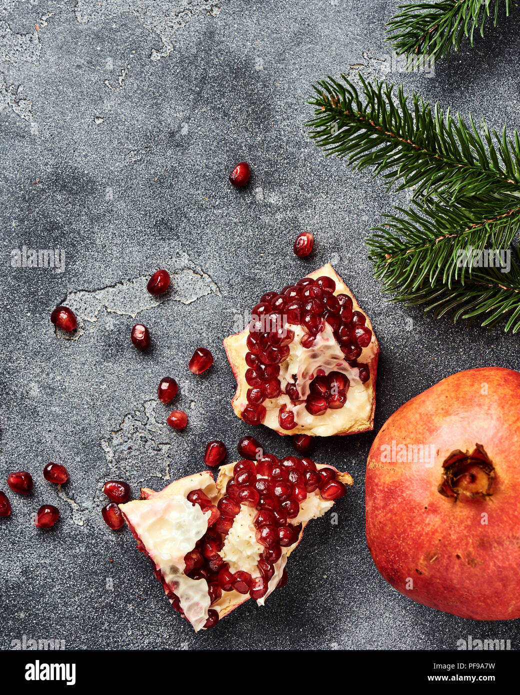 Pomegranate fruit with seeds on gray background with copy space. Top view. Stock Photo