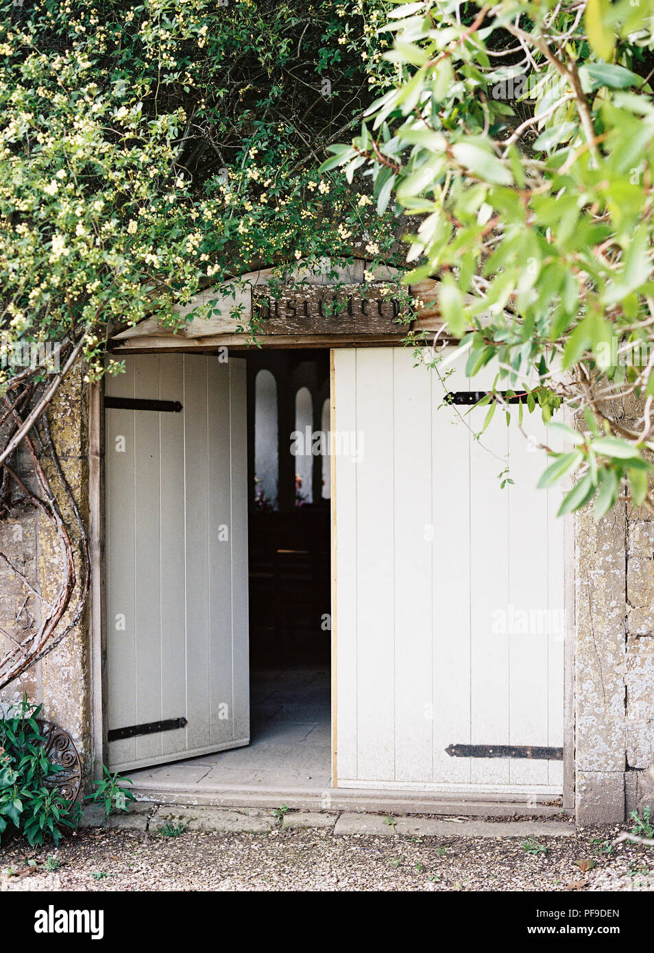 Barn doors open on chapel for countryside wedding at brympton house in somerset uk Stock Photo