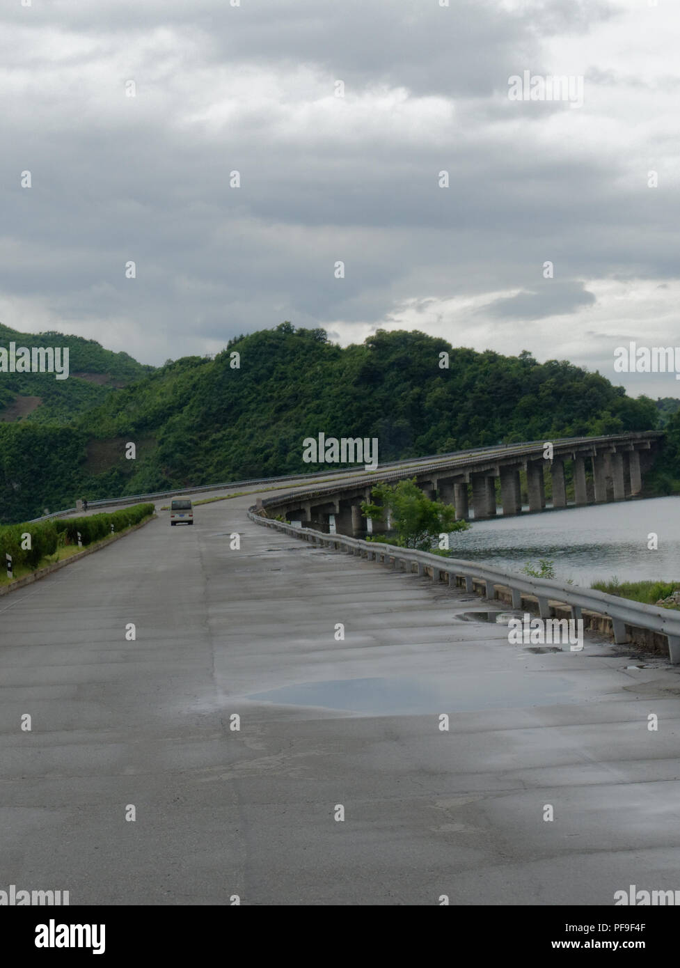 North Korea, typical empty road except for tourist coach Stock Photo