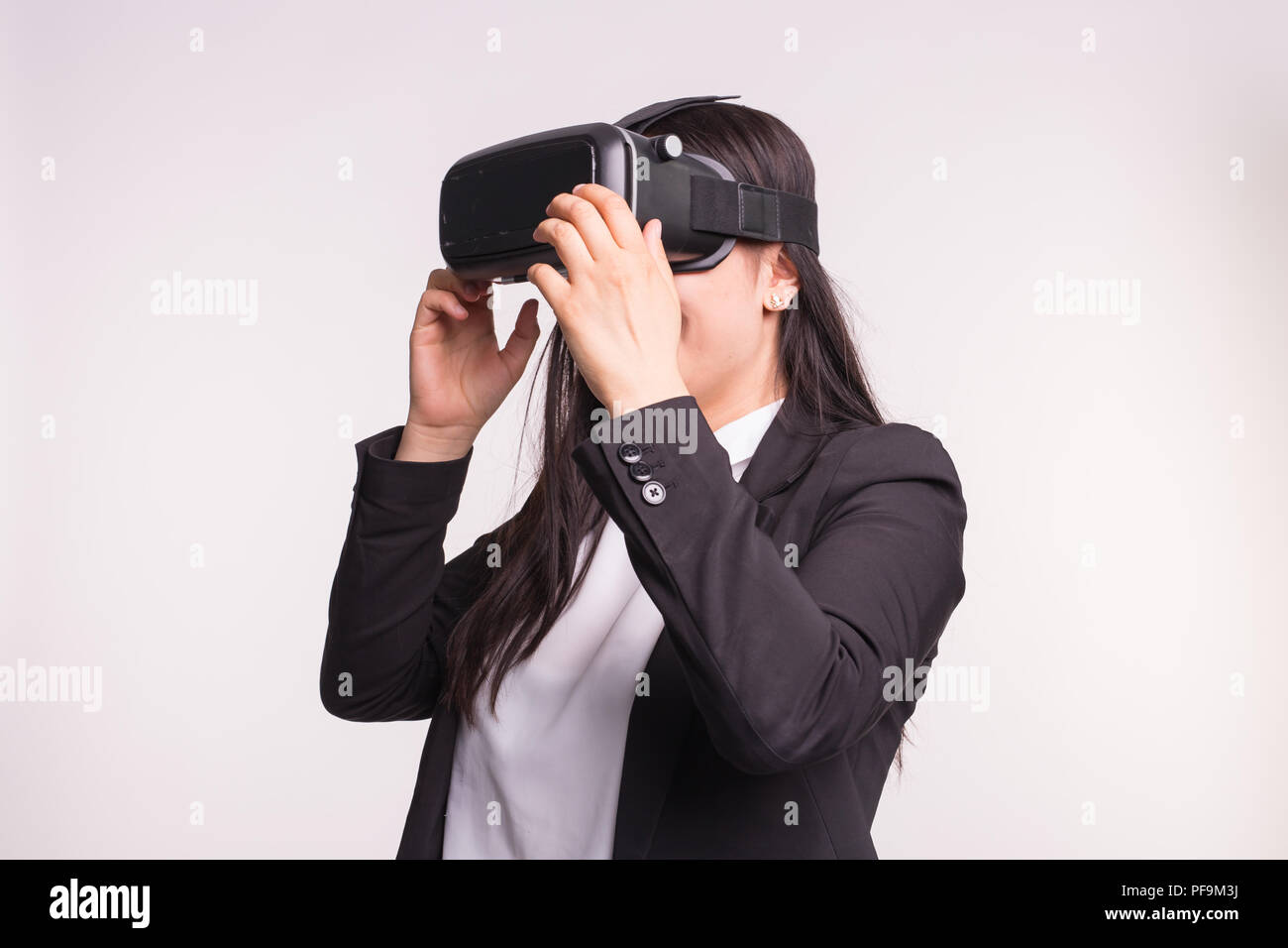 Young woman with virtual reality helmet on white background Stock Photo ...