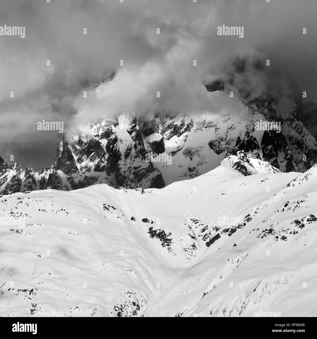 Black and white view on Mount Ushba in haze. Caucasus Mountains. Svaneti region of Georgia at winter. Square image. Stock Photo