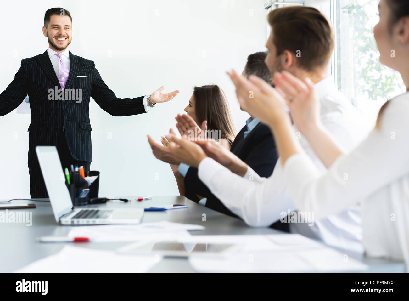 Presenting Businessman presenting to colleagues hi-res stock photography and ...