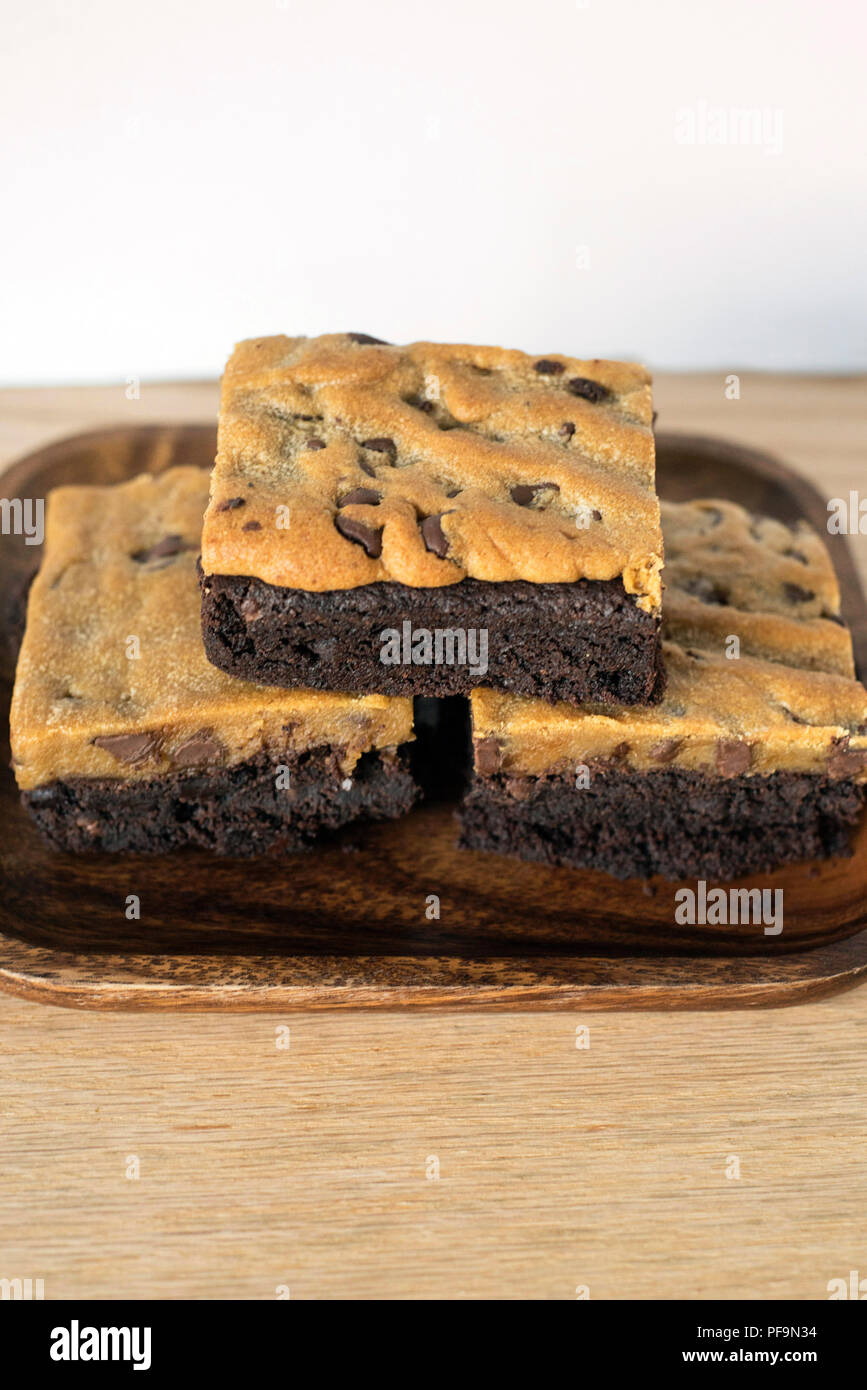 Brookie Brownie Cookie Dessert Combo Stacked on a Wooden Plate for a Treat Stock Photo
