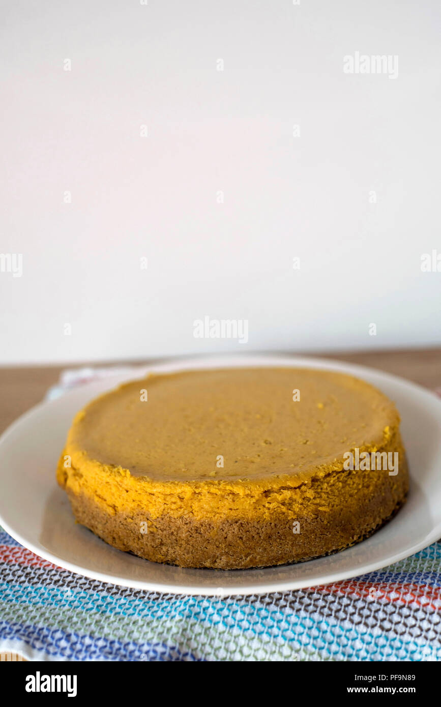 A Whole, Untouched Pumpkin Cheesecake Ready for Seasonal Celebration Stock Photo