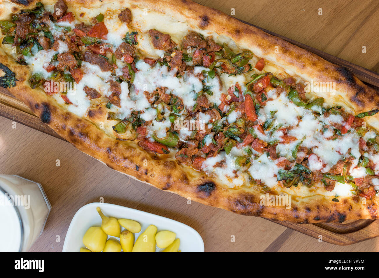 Turkish Pide with Minced Meat Kavurma Salad and Pickles. Traditional