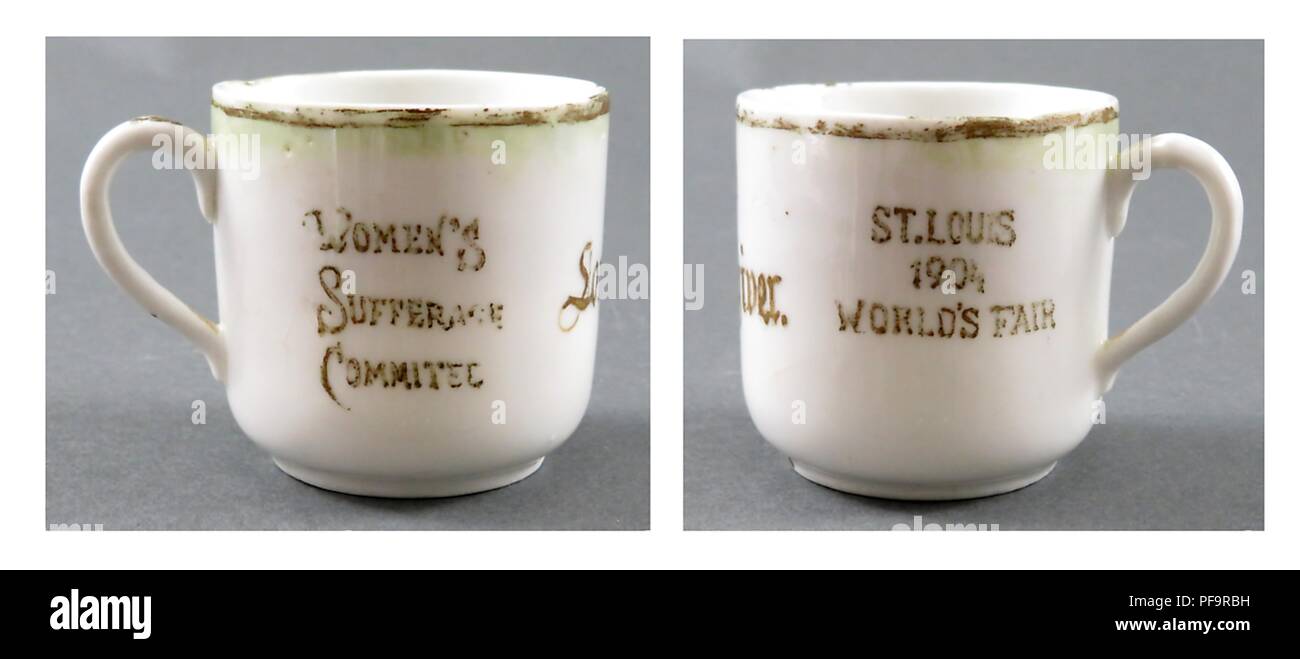 Small, china teacup, white, with brown or dark green text reading on one side 'St Louis 1904 World's Fair,' and the word suffrage intentionally misspelled in the phrase 'Women's Sufferage Committee' on the other, made in the United States of America, circa 1904, 1904. () Stock Photo