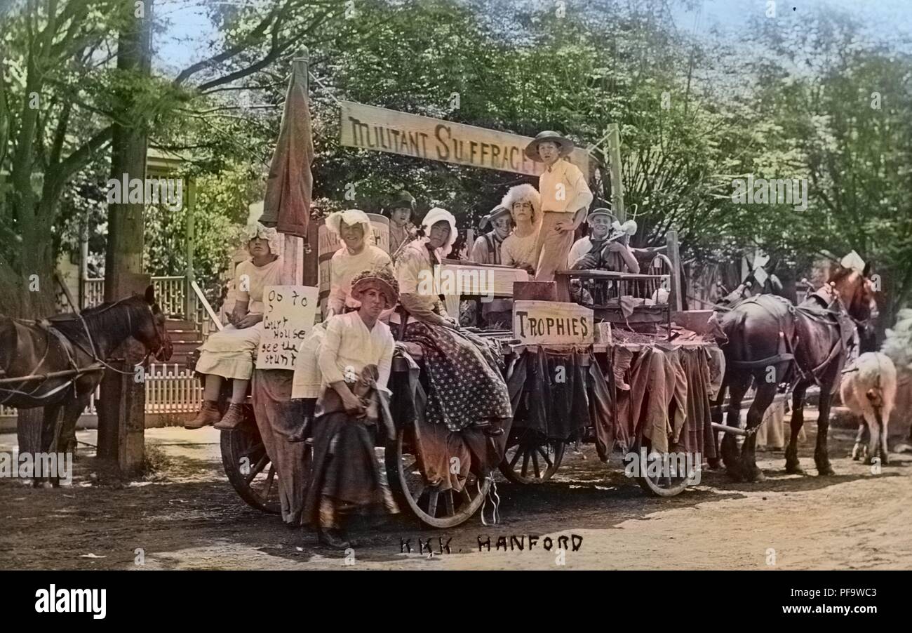 Black and white photograph showing men and boys, some dressed in women's Edwardian clothing, seated and standing on a horse-drawn, anti-suffrage float, with the words 'KKK Hanford, ' written at the bottom center, presumably identifying the Hanford chapter of the 'Ku Klux Klan', 1900. Note: Image has been digitally colorized using a modern process. Colors may not be period-accurate. () Stock Photo