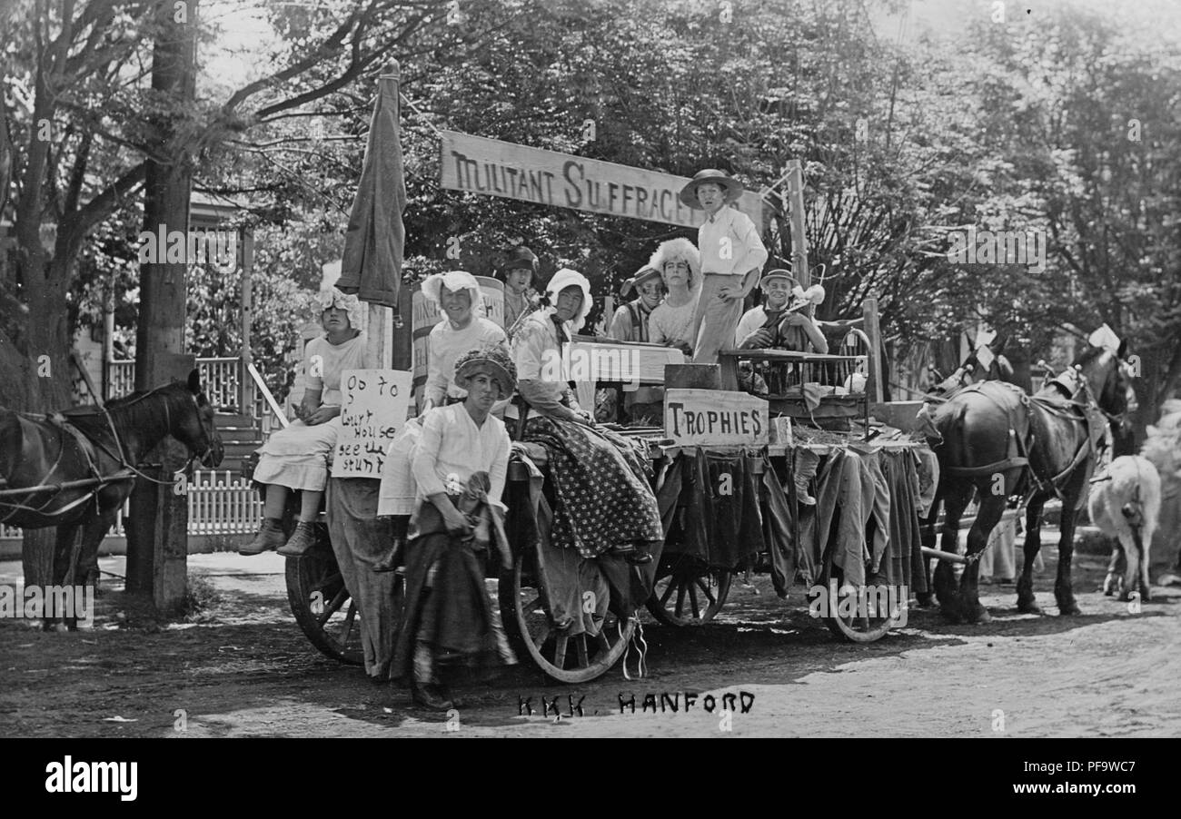Black and white photograph showing men and boys, some dressed in women's Edwardian clothing, seated and standing on a horse-drawn, anti-suffrage float, with the words 'KKK Hanford, ' written at the bottom center, presumably identifying the Hanford chapter of the 'Ku Klux Klan', 1900. () Stock Photo