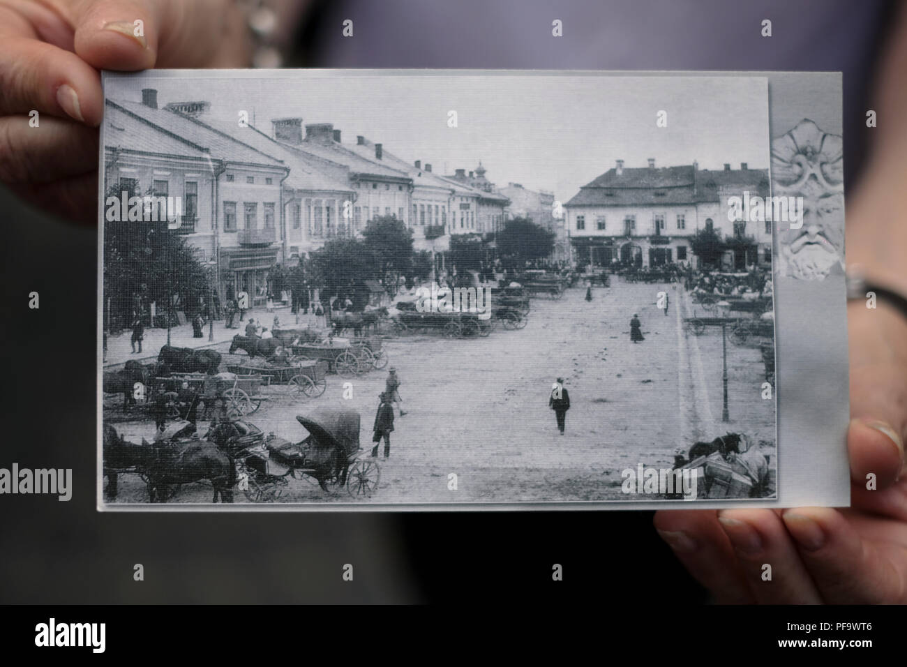 A person holds old photographs of the city of Drohobych in Lviv Oblast, Ukraine which was once home to a large Jewish community and was annihilated by the Germans during the Second World War Stock Photo