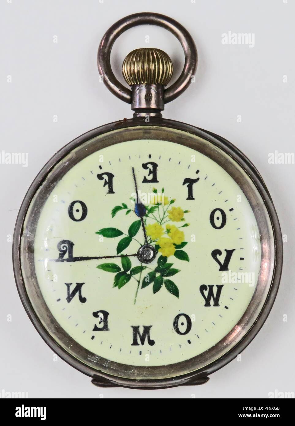 Silver-colored, pro-suffrage pocket watch or fob watch, with the phrase 'Vote for Women,  with each letter corresponding to a numeral, and a yellow and green rose on the enamel face, 1900. Photography by Emilia van Beugen. () Stock Photo