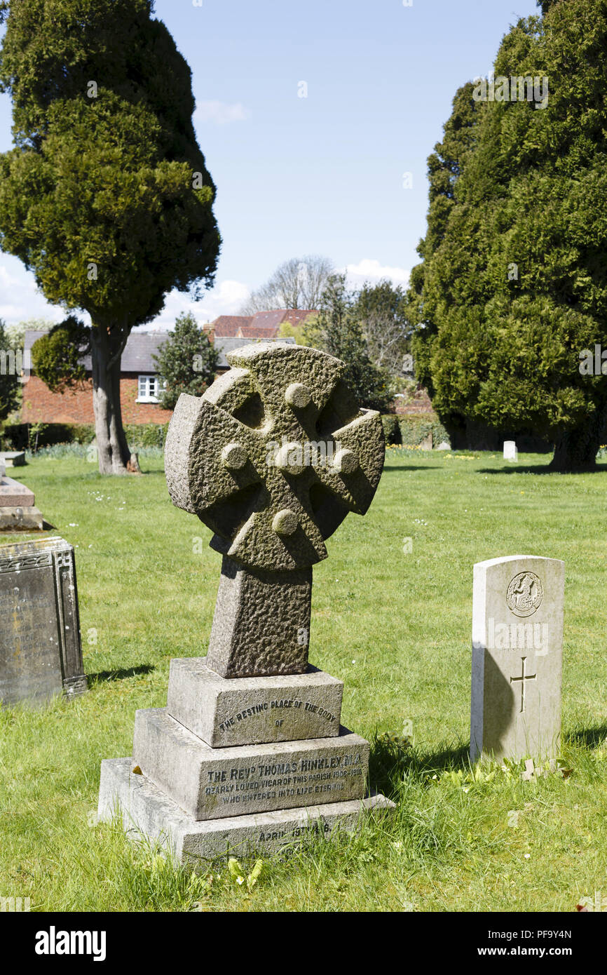 Winslow, UK - April 27, 2015. Gravestone with cross at a church graveyard in the historic town of Winslow, Buckinghamshire Stock Photo