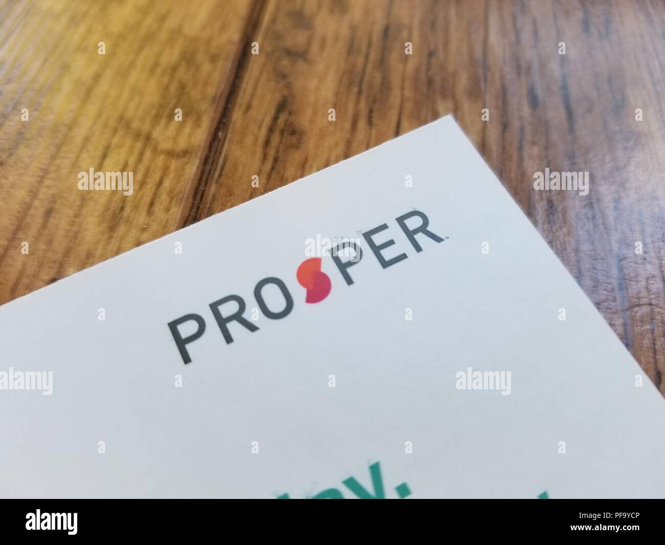 Close-up of logo for peer to peer lending company Prosper on a piece of white paper against a light wooden background, San Ramon, California, February 4, 2018 Stock Photo