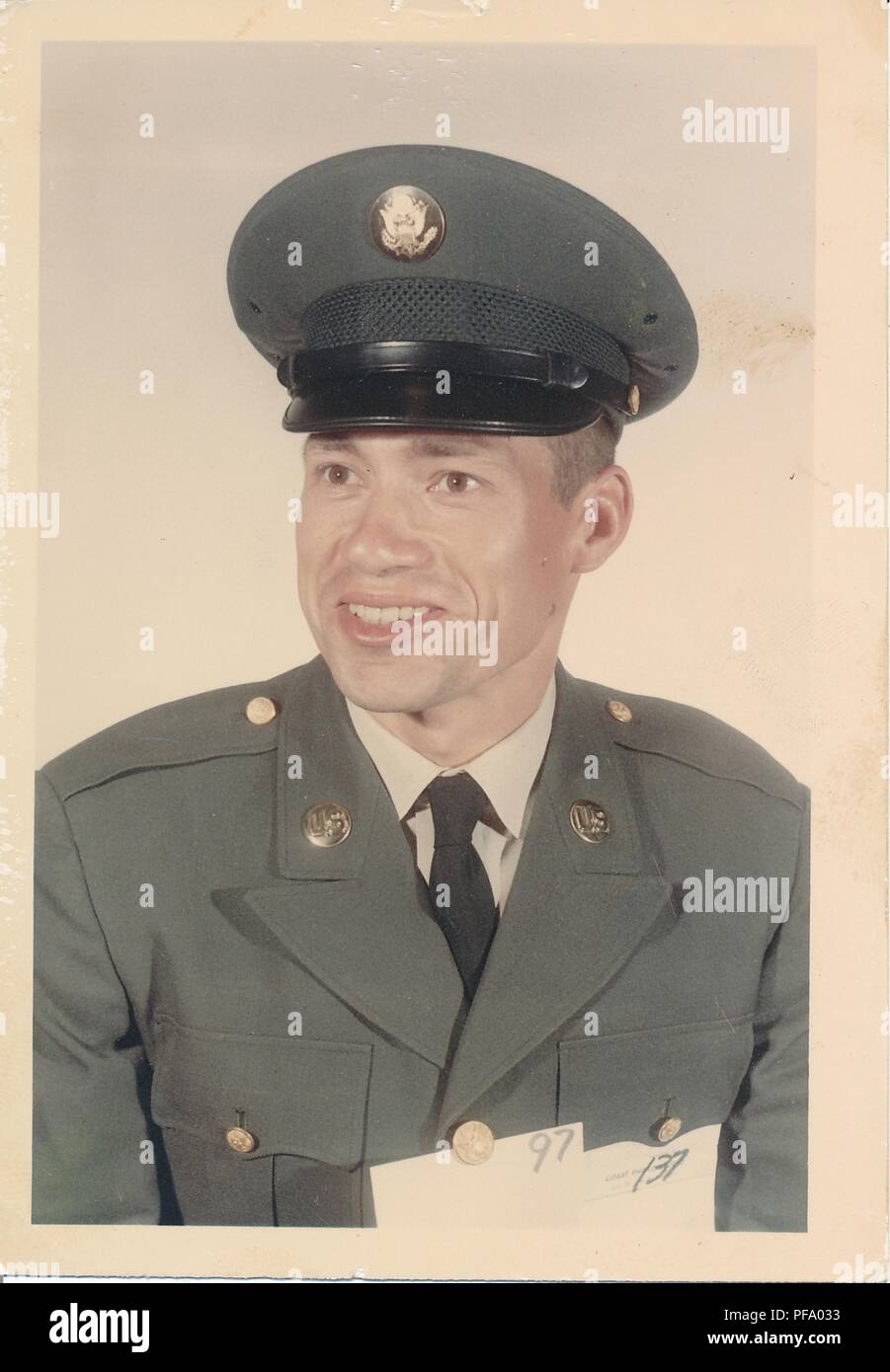 Color photograph of a male, US Army member, shown in three-quarter profile view, from the chest up, wearing hat and uniform, and smiling, 1984. () Stock Photo