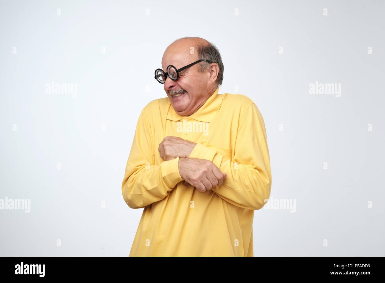 Mature man in funny glasses looking with disgust emotion on face. Bad smell concept Stock Photo