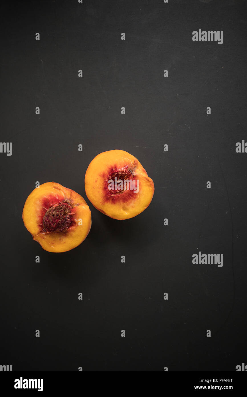 half peach on black background Stock Photo