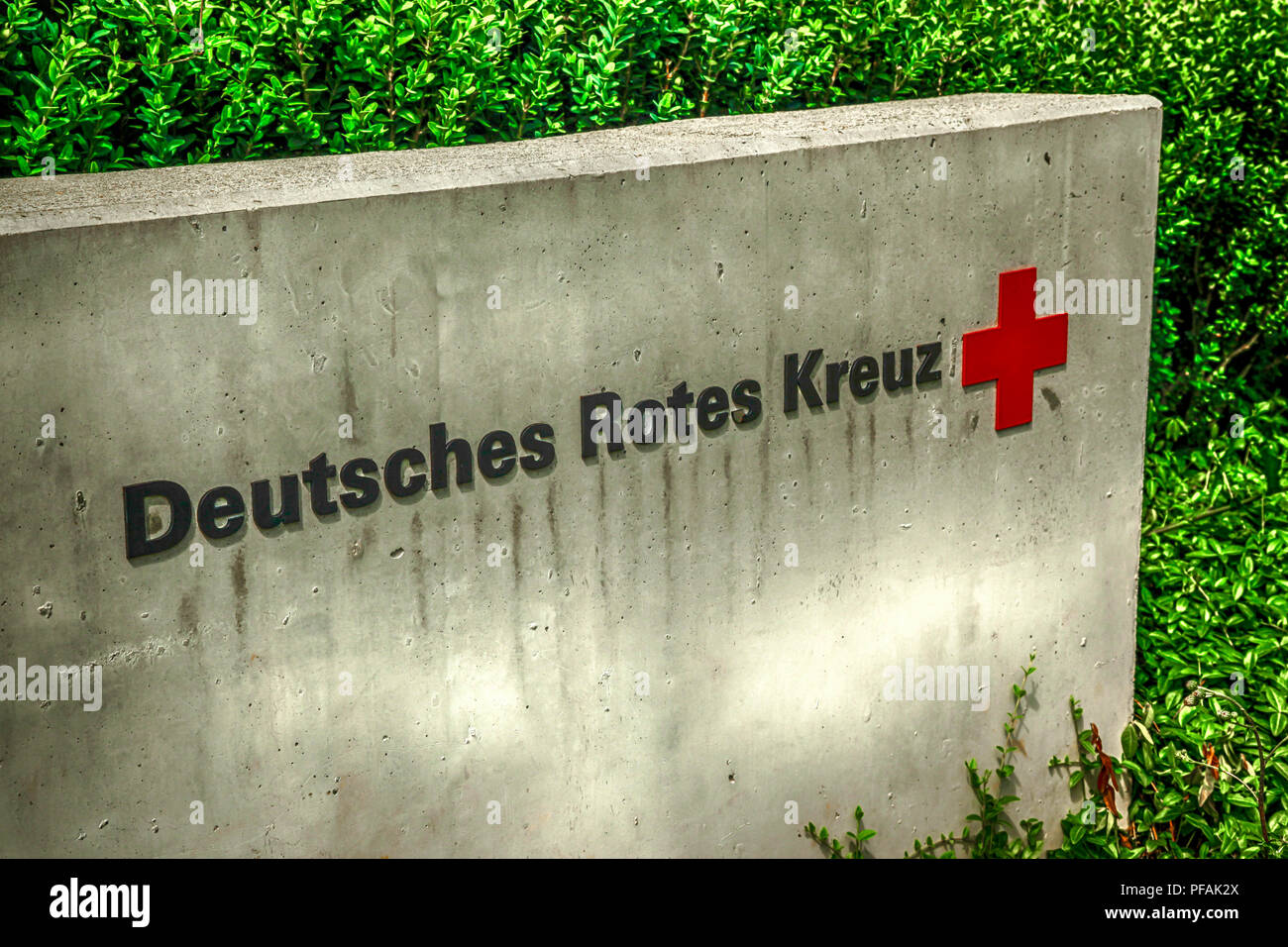 The concrete sign for the German Red Cross, or the Deutsches Rotes Kreuz located outside an ambulance station in Ulm, Germany. Stock Photo