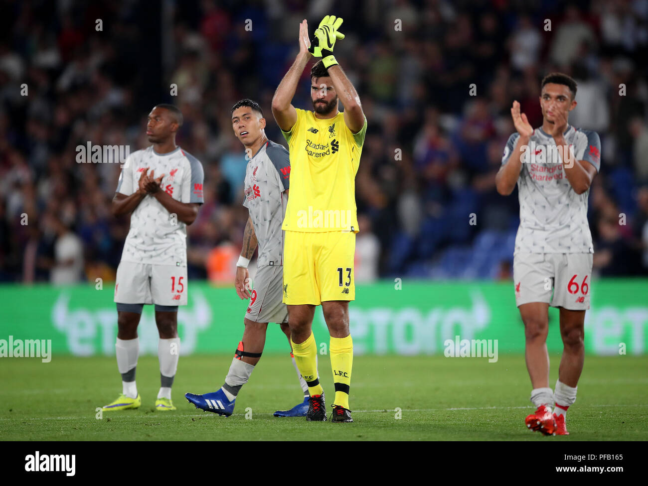Liverpool goalkeeper Alisson Becker applauds the fans after the Premier ...