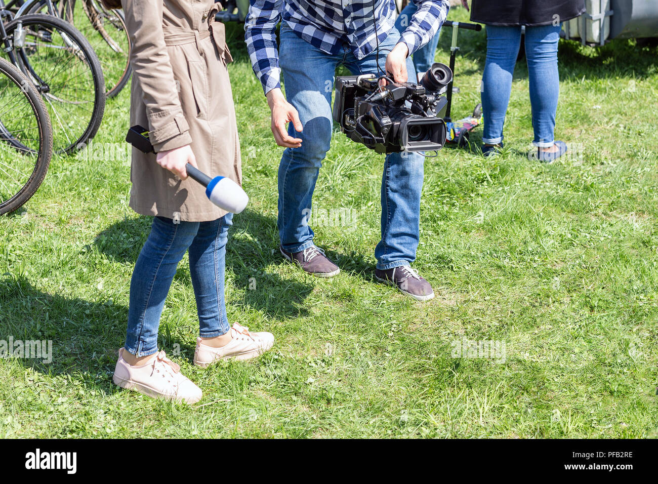 TV reporters working outdoors. Journalsit and cameraman making report