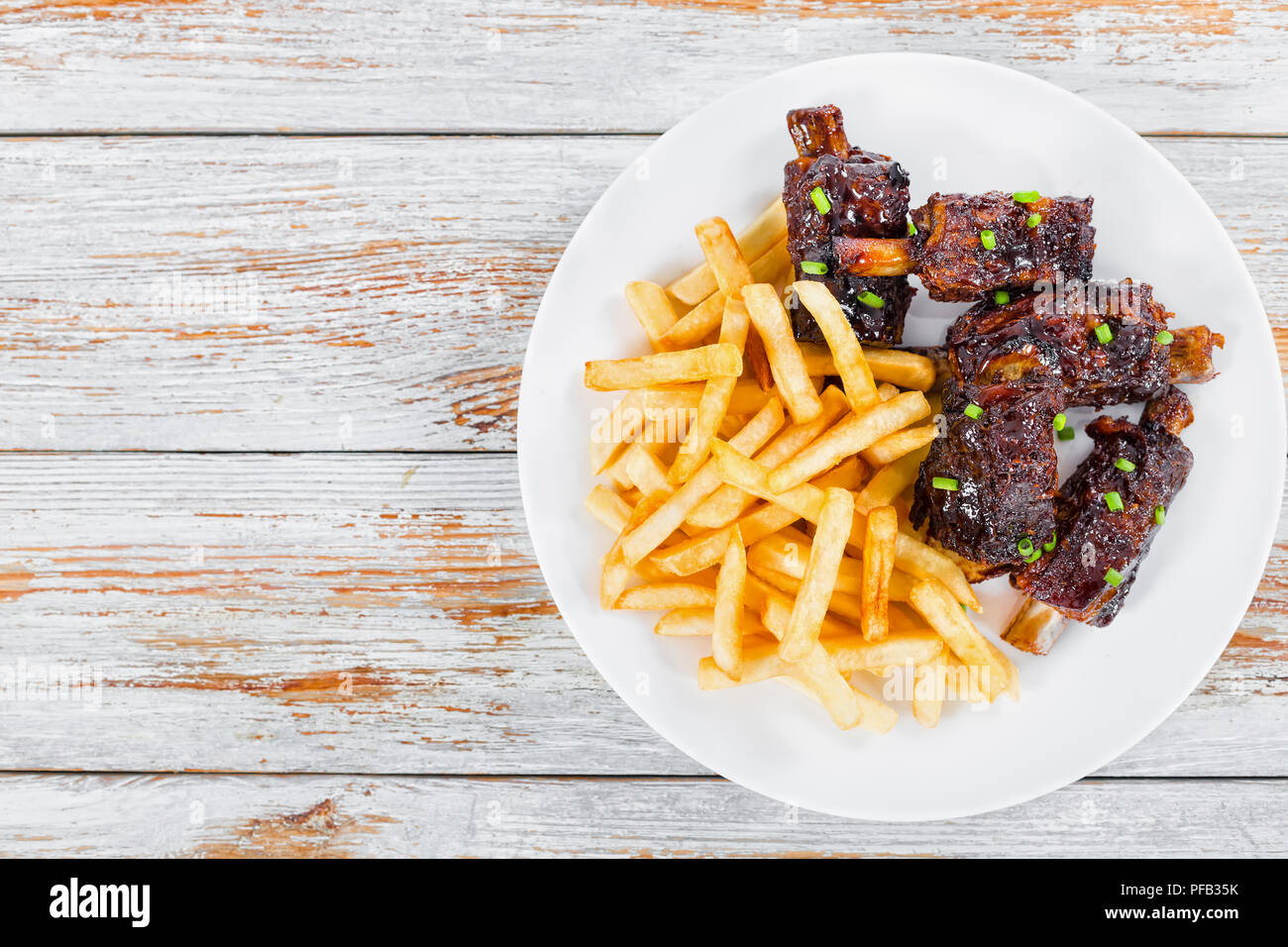 french fries with fried sticky ribs marinated in soy sauce and ginger