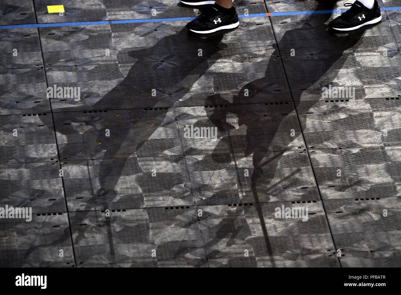 Shadows from a pair of archers decorate a floor during practice for the 2018 Warrior Games at the Air Force Academy in Colorado Springs, Colo. June 1, 2018. Stock Photo