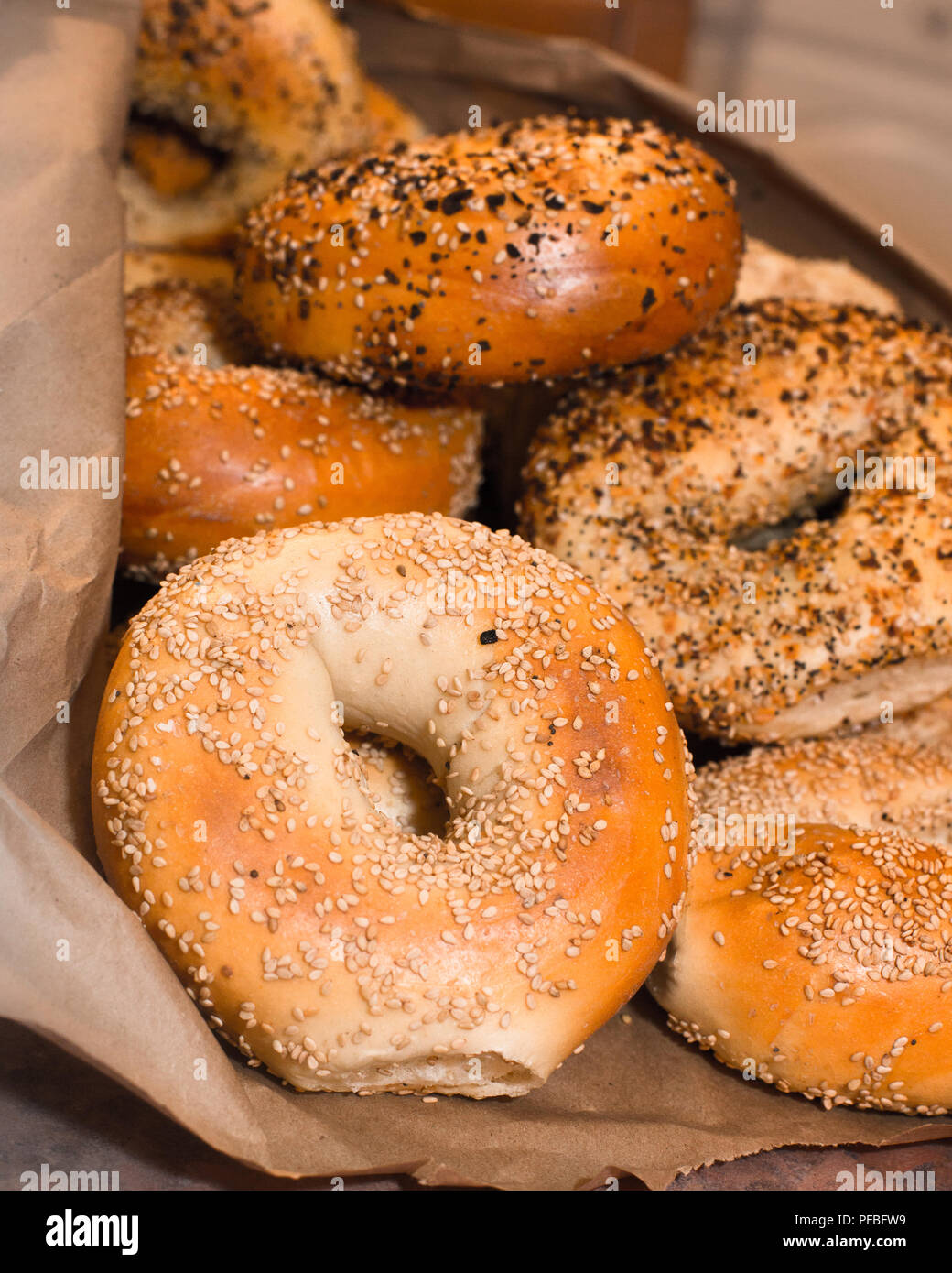 Variety of assorted authentic New York style Bagels with seeds in a brown paper bag Stock Photo