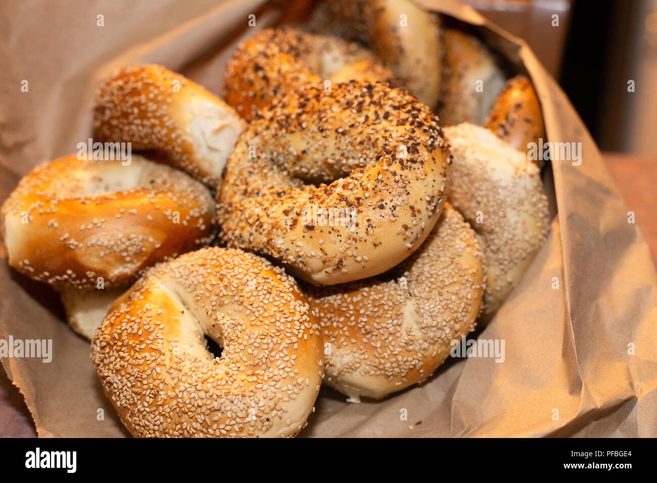Variety of assorted authentic New York style Bagels with seeds in a brown paper bag Stock Photo