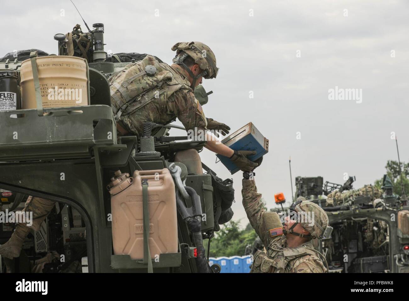 4th Squadron, 2d Cavalry Regiment soldiers receive a simulated full combat load of ammunition for a Stryker Infantry Carrier Vehicle at the ammunition transfer and holding point in Powidz, Poland, June 1, 2018. Each squadron will receive training rounds at the ATHP en route to Lithuania for Saber Strike 18. Stock Photo