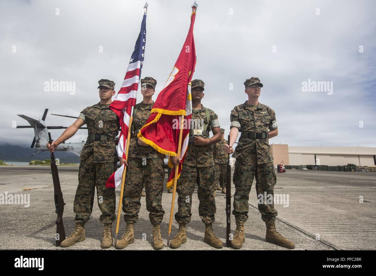 U.S. Marines with Marine Unmanned Aerial Vehicle Squadron 3 (VMU-3) color guard standby before a change of command ceremony, Marine Corps Air Station Kaneohe Bay, Marine Corps Base Hawaii, June 7, 2018. Lt. Col. Kenneth Phelps retired and relinquished command of VMU-3 to Lt. Col. Peter Ban. Stock Photo