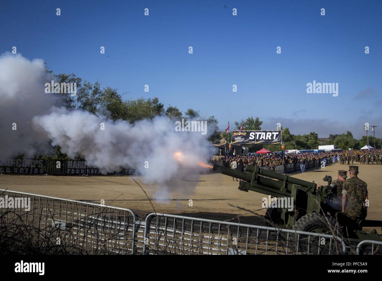A M105 Howitzer fires, starting the 2018 Mud Run Commanding General’s Cup Team Competition on Marine Corps Base Camp Pendleton, Calif., June 8, 2018. The race stretched over 10-kilometers around Lake O’Neill on MCB Camp Pendleton. Over 2,000 Marines from numerous units around California and neighboring states participated in the challenge. Stock Photo
